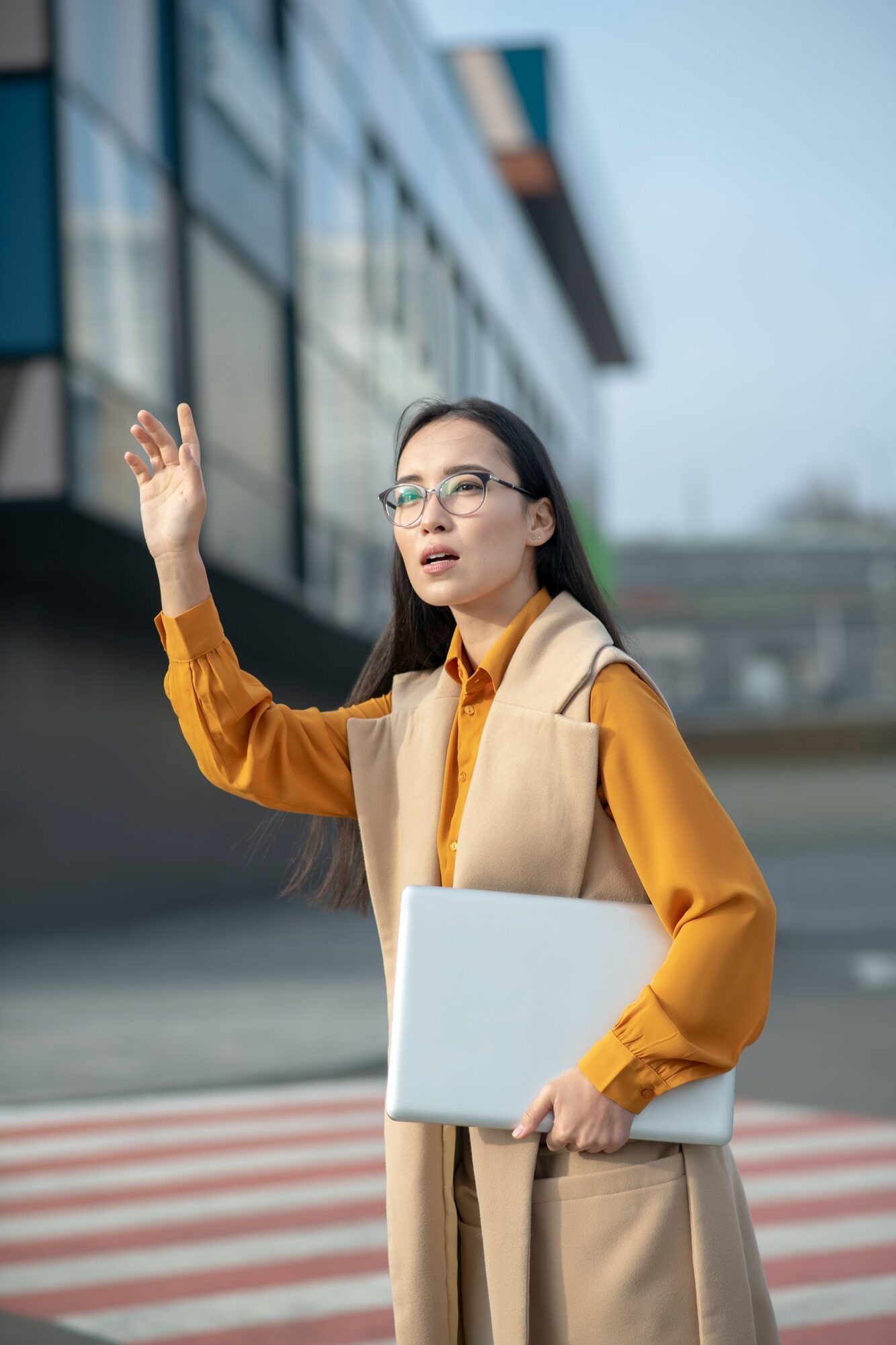 young-asian-pretty-woman-waving-her-hand-on-the-road.jpg