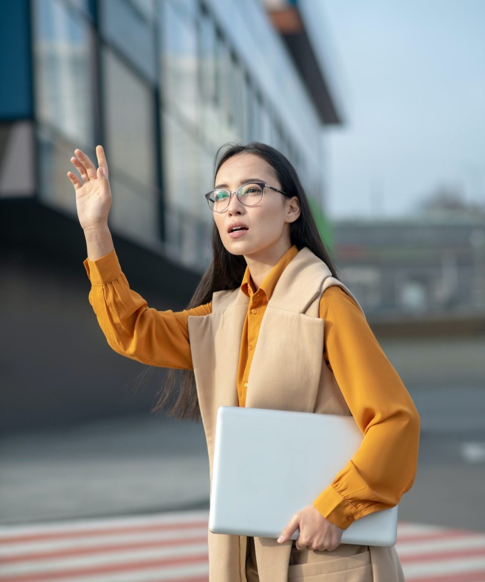 young-asian-pretty-woman-waving-her-hand-on-the-road.jpg